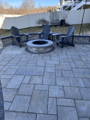new patio installation with stone firepit